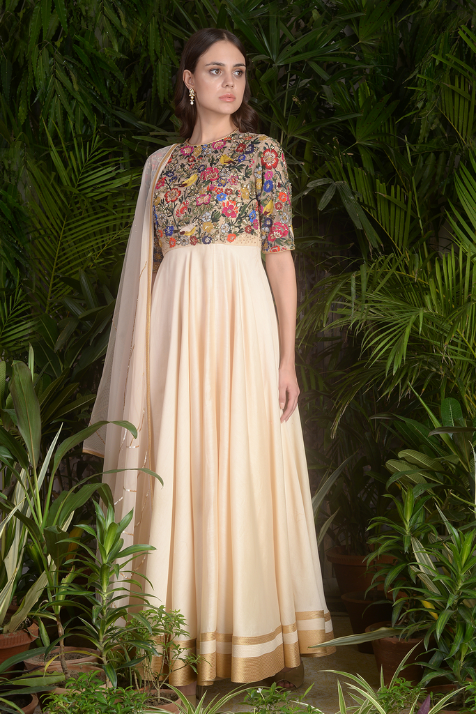 a woman in a dress standing in a garden 