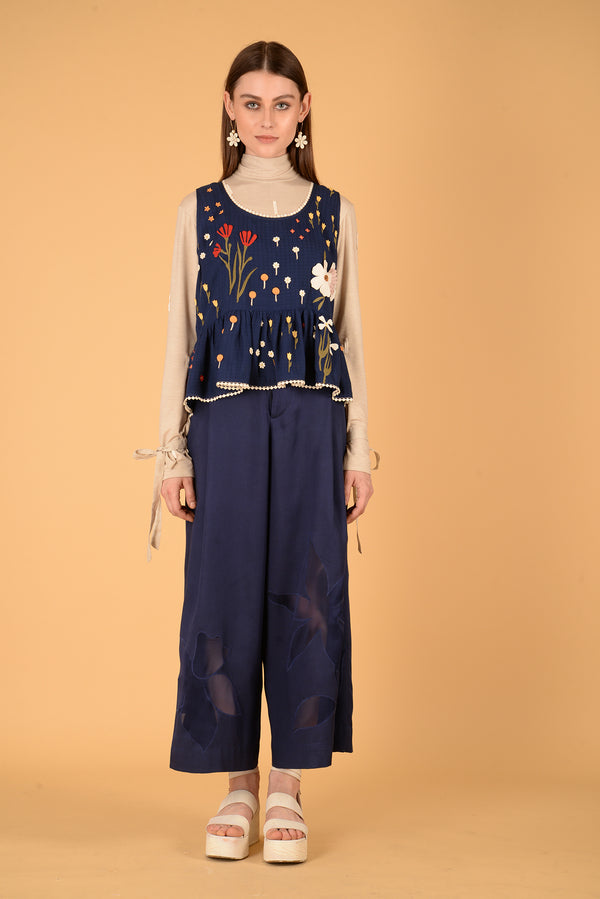 a woman standing next to a man holding a tennis racquet 