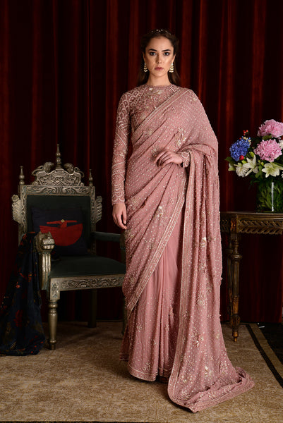 a woman in a pink dress standing in a room 